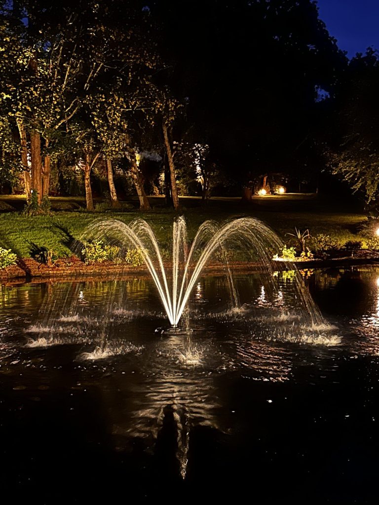 Illuminated fountain in a garden lake, Sevenoaks