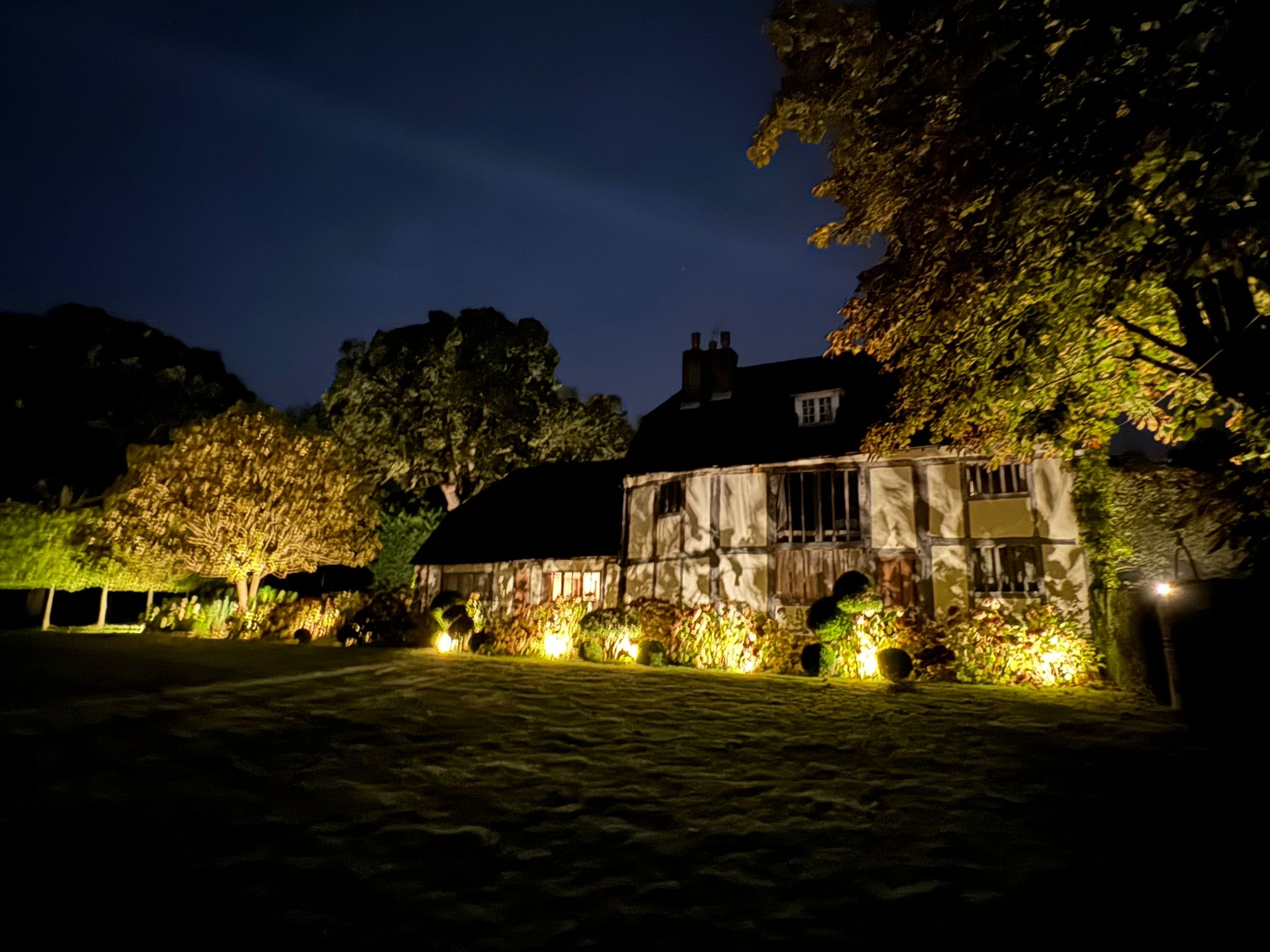 Historic timber-framed house and trees lit at night, Tonbridge garden lighting